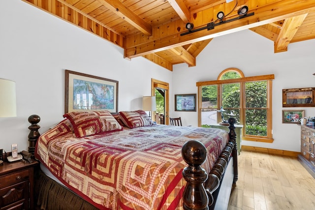 bedroom featuring wood ceiling, light hardwood / wood-style floors, and lofted ceiling with beams