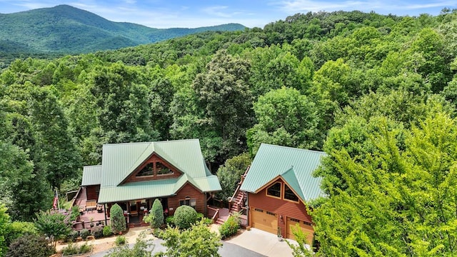 drone / aerial view with a mountain view and a view of trees