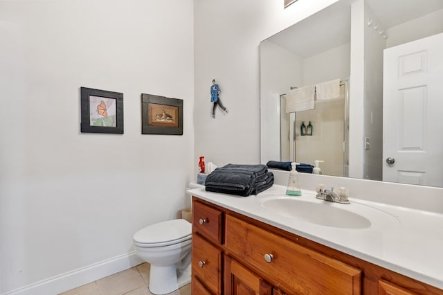 bathroom featuring vanity, tile patterned floors, and toilet