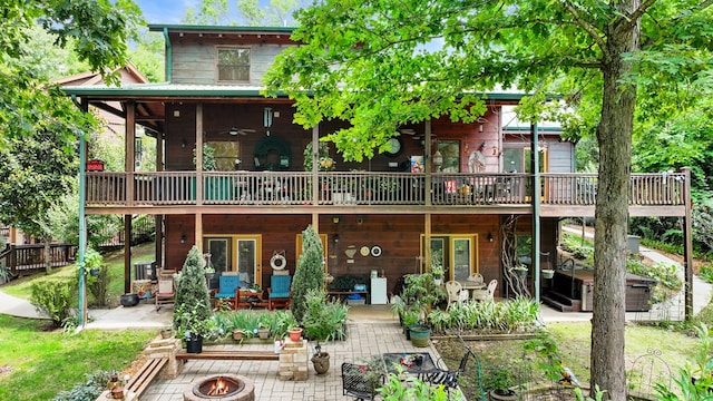 back of house with a patio, a deck, ceiling fan, and a fire pit