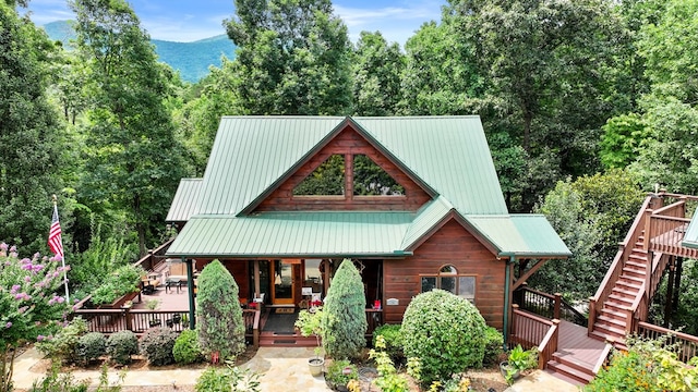 view of front of home with a deck with mountain view