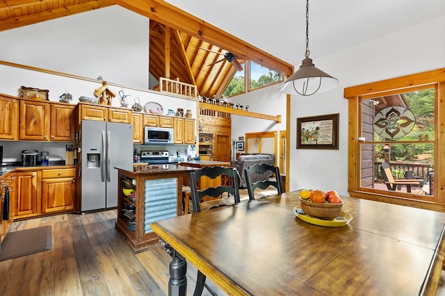 dining area with beamed ceiling, plenty of natural light, dark hardwood / wood-style floors, and high vaulted ceiling