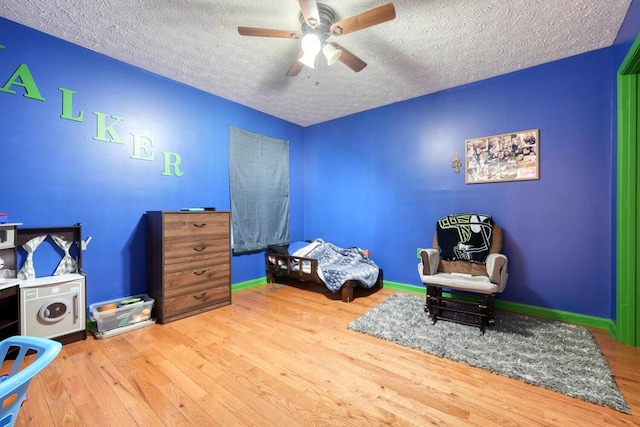 bedroom featuring a textured ceiling, ceiling fan, and light wood-type flooring