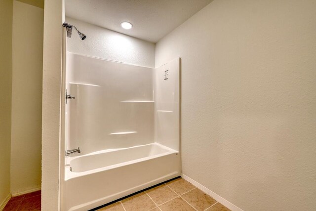 bathroom with shower / washtub combination and tile patterned flooring