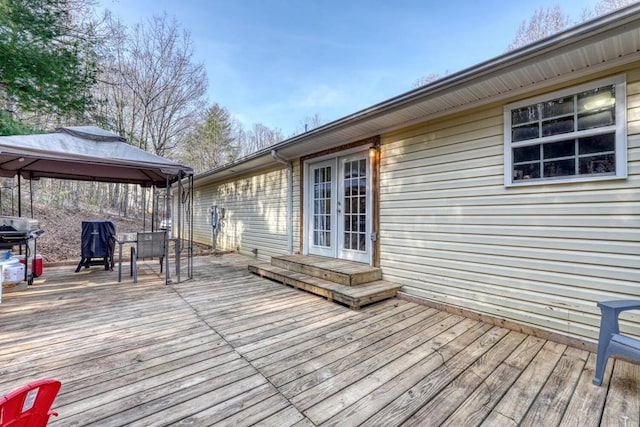 deck featuring a gazebo and french doors