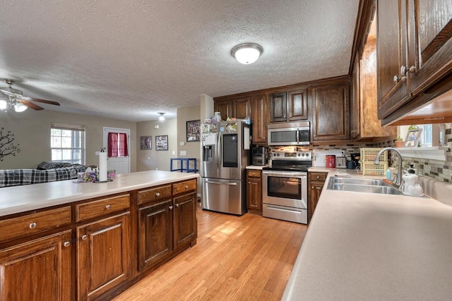 35 Deer Run Rd, Blairsville, GA 30512 - kitchen featuring appliances with stainless steel finishes, a sink, light wood-style floors, light countertops, and a textured ceiling