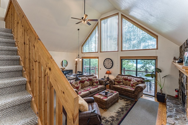 40 White Cloud Dr, Murphy, NC 28906 - living room featuring wood finished floors, a ceiling fan, a fireplace, stairway, and high vaulted ceiling