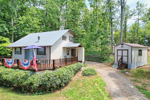 view of front of property with a wooden deck and a shed