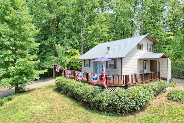 rear view of house with a deck and a lawn