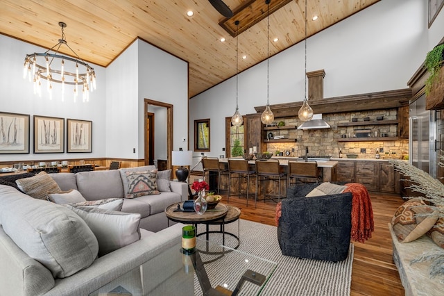 living room with wood finished floors, recessed lighting, a high ceiling, an inviting chandelier, and wooden ceiling