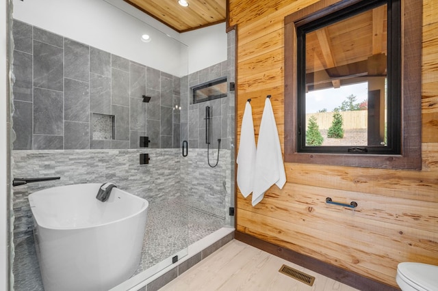 bathroom featuring visible vents, a soaking tub, recessed lighting, a stall shower, and toilet