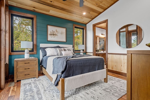 bedroom featuring lofted ceiling, multiple windows, wood ceiling, and light wood finished floors