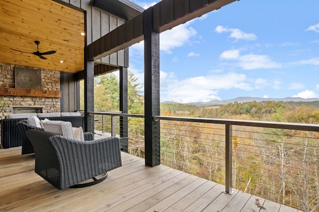 wooden terrace with a mountain view and ceiling fan