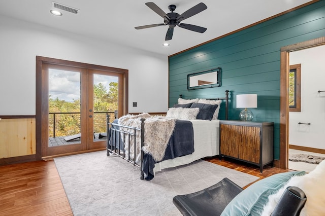 bedroom featuring visible vents, access to outside, wood finished floors, recessed lighting, and french doors