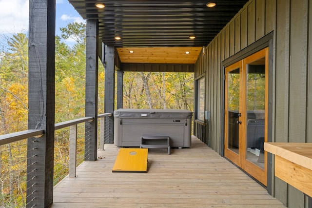 deck featuring french doors and a hot tub