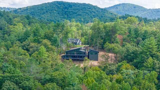 drone / aerial view with a mountain view and a wooded view