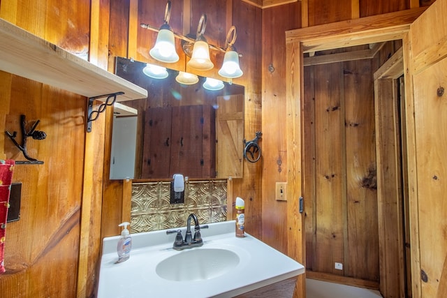 bathroom featuring vanity and wooden walls