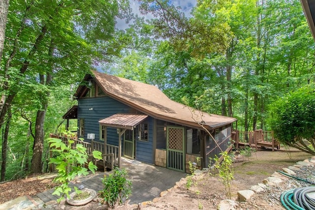 view of front facade featuring a sunroom and a deck