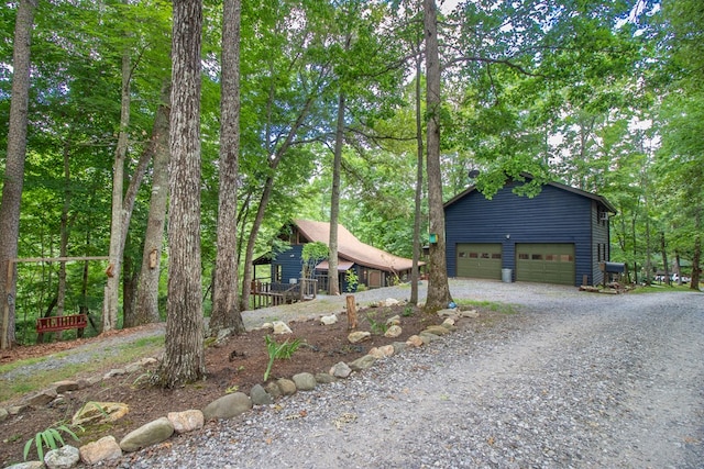 view of front of property featuring a garage and an outdoor structure