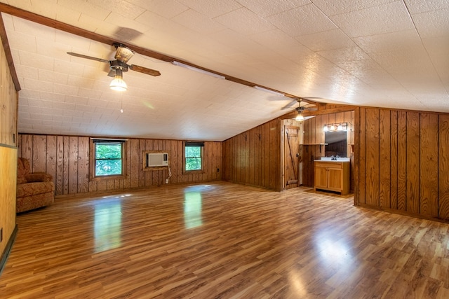 bonus room with ceiling fan, lofted ceiling, a wall mounted AC, and hardwood / wood-style floors