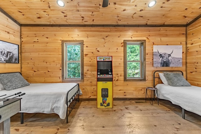 bedroom with hardwood / wood-style floors, multiple windows, and wood ceiling