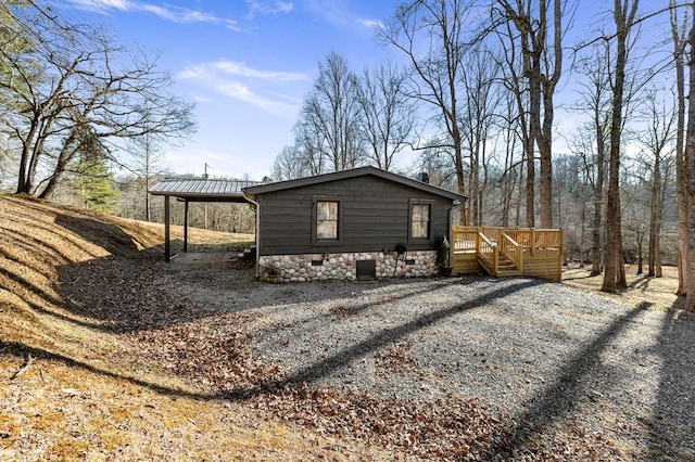 view of side of property featuring a wooden deck