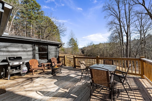 deck with a grill and a fire pit