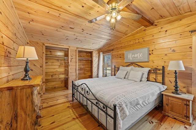 bedroom featuring wood ceiling, lofted ceiling with beams, light hardwood / wood-style flooring, and wood walls