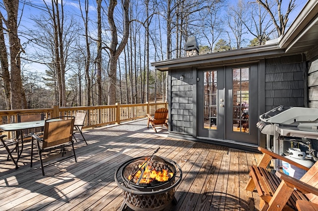 deck with french doors and a fire pit