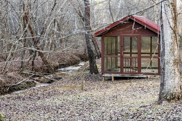 view of outbuilding with a water view