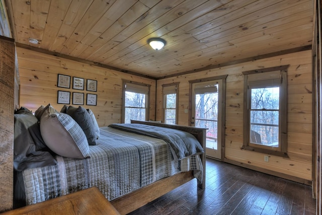 bedroom with access to outside, dark hardwood / wood-style floors, wooden walls, and wood ceiling