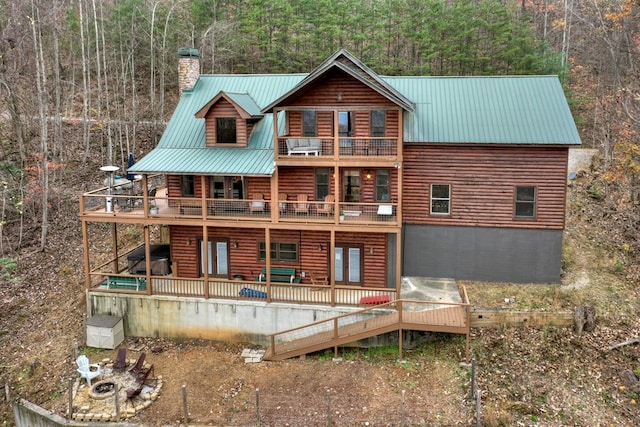 back of property featuring a balcony