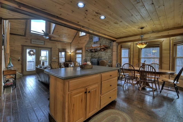 kitchen featuring wooden ceiling, pendant lighting, dark wood-type flooring, and wood walls