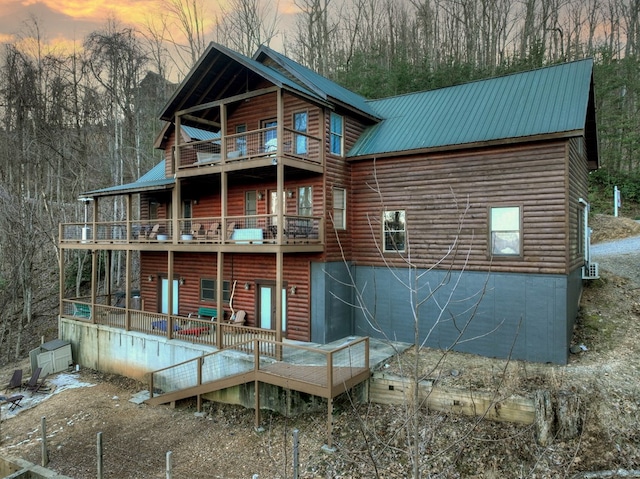 back house at dusk with a balcony