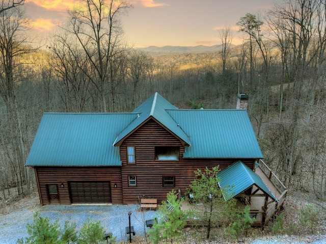 exterior space featuring a garage and a mountain view