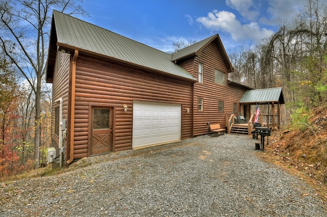 view of side of property featuring a garage and a wooden deck