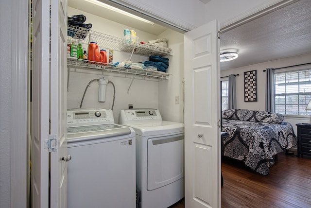 washroom featuring laundry area, dark wood-style floors, washing machine and dryer, and a textured ceiling