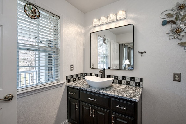 bathroom with vanity and a textured wall