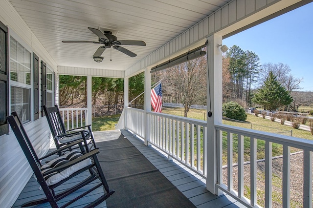 wooden terrace featuring a porch and ceiling fan