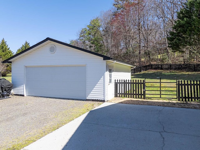 detached garage featuring fence