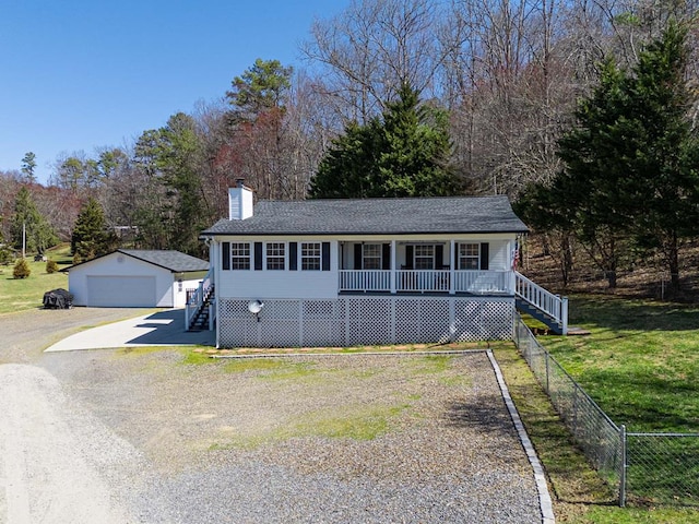 view of front of home featuring stairs, a front yard, covered porch, a chimney, and an outbuilding