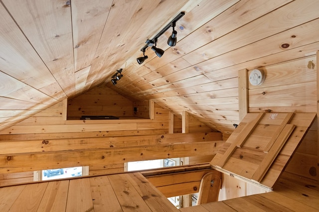 bonus room featuring vaulted ceiling with skylight, wooden ceiling, and wooden walls