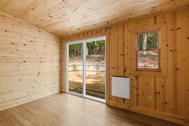 doorway to outside with lofted ceiling, plenty of natural light, and light hardwood / wood-style floors