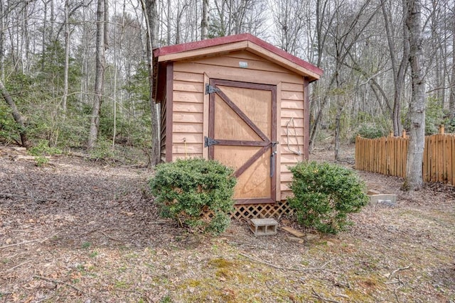 view of shed with fence