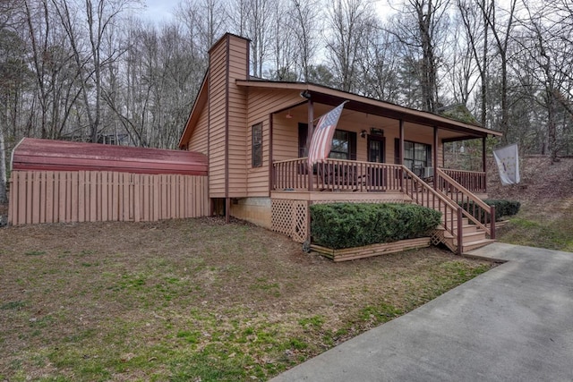 view of front of home featuring a porch and a chimney