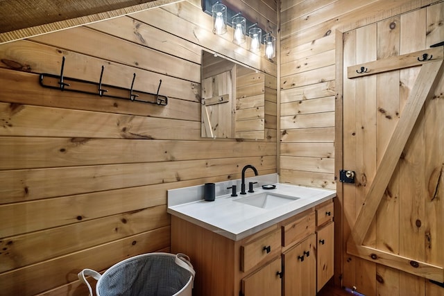 bathroom featuring wooden walls and vanity