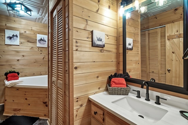 bathroom with wood walls, a closet, and vanity