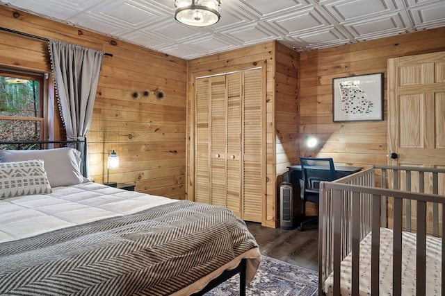 bedroom featuring an ornate ceiling, a closet, and wooden walls