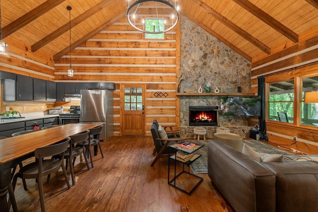 living area with dark wood-style floors, lofted ceiling with beams, a fireplace, and wood ceiling