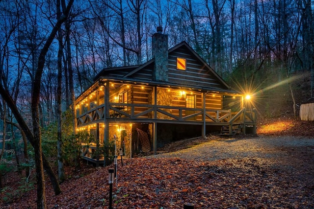 back of property with a chimney